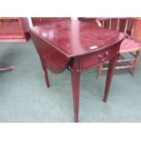 A reproduction drop leaf table with single drawer to front.