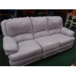 A three seater reclining sofa in lilac leather.