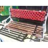 A cast iron garden bench with wooden slats.