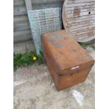 A tin trunk and a case together with a dog cage.