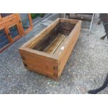 A wooden trough planter.