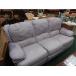 A three seater reclining sofa in lilac leather.