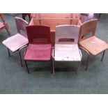 A set of four children's stacking chairs.