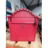 A Gardeco metal post box painted red with keys.