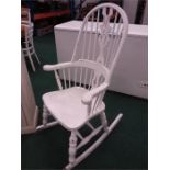 A large white painted stickback rocking armchair.