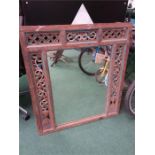 A wooden carved framed mirror.