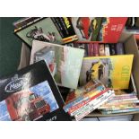 A box containing videos, books,headphones, DVD player and microphones.