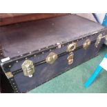 A metal bound travel trunk.