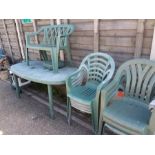 A garden patio set consisting of table, eight chairs, a bench and a drinks trolley.