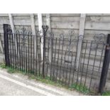 A pair of ornate driveway gates with pillars.