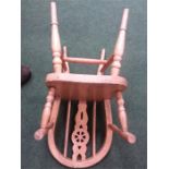 A beechwood child's wheelback elbow chair.