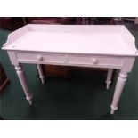 An Edwardian pine washstand painted white .