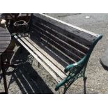 A cast iron garden bench with wooden slats.