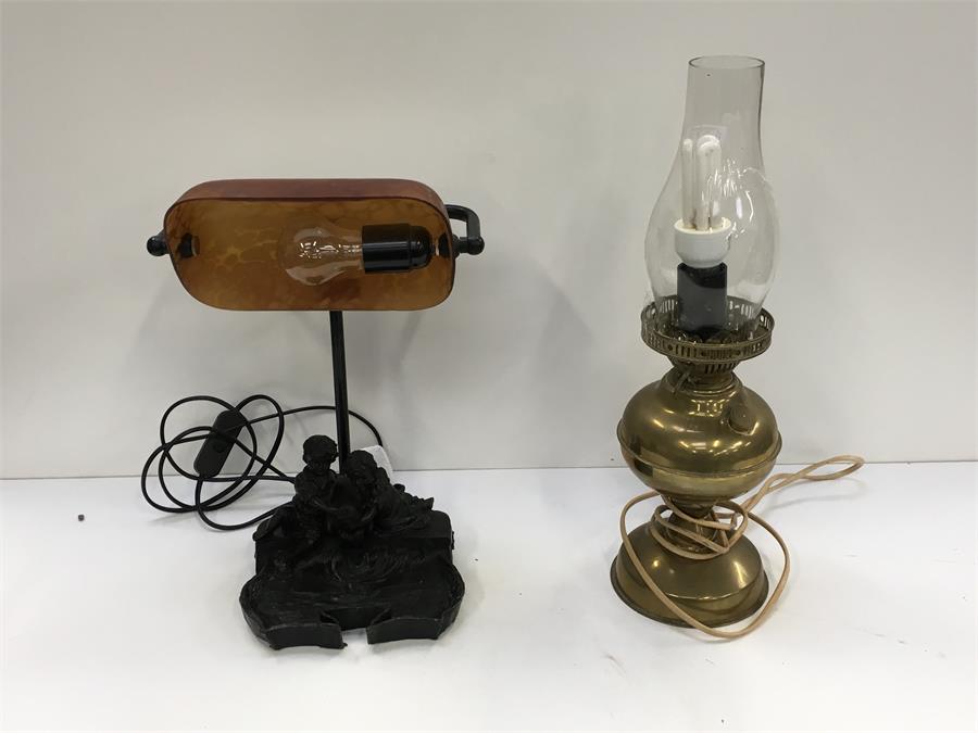 A resin desk lamp depicting a girl and boy together with a brass table lamp. - Image 2 of 2