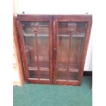 Wall hanging cupboard in oak with glazed panelled doors and two shelves. (30" wide x 35" high).