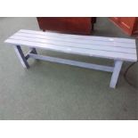 A wooden blue painted bench.