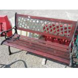 A cast iron garden bench with lattice back.