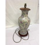 A large oriental lamp base on wooden stand.