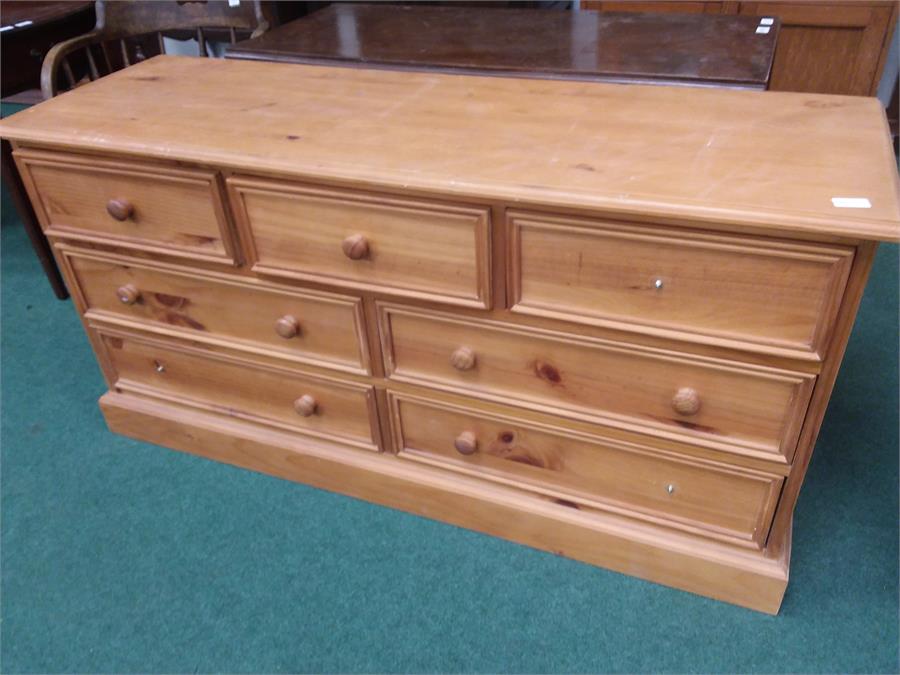 A seven drawer pine chest of drawers.