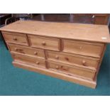 A seven drawer pine chest of drawers.