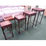 A nest of four Chinese hardwood stacking tables .