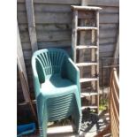 A six tread painter's stepladder together with eleven stacking plastic chairs.