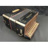 A Hohner wooden accordion.