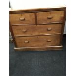 An early 20th century faded mahogany chest of two short drawers over two long drawers with wooden