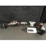 Four various vintage film cameras to include Nikon, Minolta and two others together with two cases