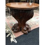 A 19th century mahogany small occasional table with single column based modelled as two lion paw