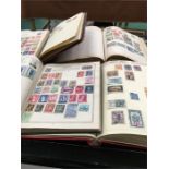 Seven stamp albums of mixed stamps.