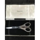 A boxed pair of silver handled grape scissors from The Alexander Clark Company Limited.