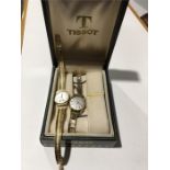 An 18ct gold wristwatch and strap together with a similar 9ct gold Tissot wristwatch.