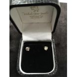 A pair of diamond stud earrings (.50 Points) set in 18ct white gold.