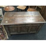 An early oak coffer with with decorative front panels and candle box to interior.