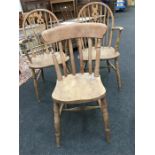 A pair of stripped Windsor carver chairs and one single Windsor.
