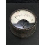 A vintage metal gauge/meter.