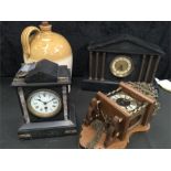 Two black marble mantle clocks together with another clock and a large jug.