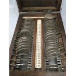 A small box of vintage lenses (Rayner of New Bond Street, London) in wooden box together with a