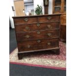 An early oak chest with two small and three long drawers, brass drop handles and escutcheons resting