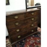 A 19th century mahogany chest of drawers with brass drop handles resting on bracket feet.