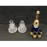 A Bohemian blue decanter with five glasses together two other glass decanters and other various