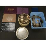 A box and a tin of assorted British and foreign coins together with 5 coin packs.