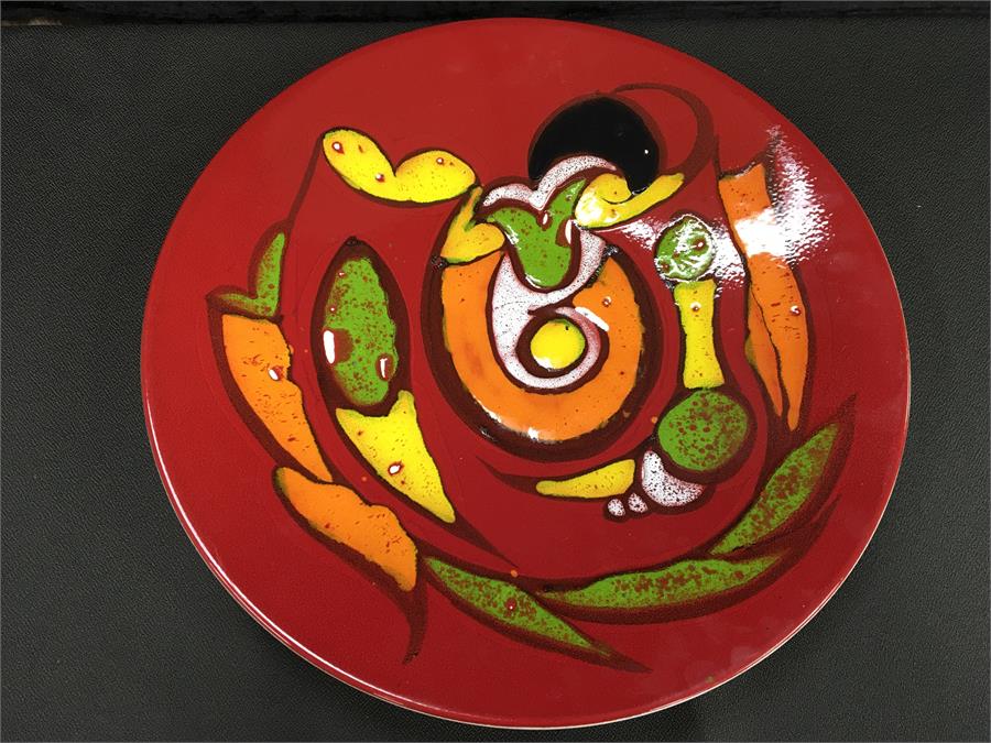 A large Poole Pottery charger in good condition (16 inches).
