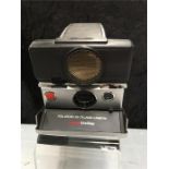 A Polaroid six-70 Land camera Sonar One Step with an Eastman Kodak Co. camera, a six-20 Kodak Junior