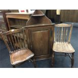 A pair of early 20th century kitchen chairs together with a 19th century oak wall hanging corner