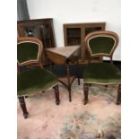 A pair of Victorian mahogany dining chairs with upholstered seats and backs together with a fold
