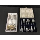 Two boxed sets of silver teaspoons.