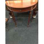 A reproduction mahogany Demi-lune console table with frieze drawer to front.