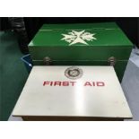 A retro wooden First Aid box with a St. Johns Ambulance First Aid box, both filled with dressings,